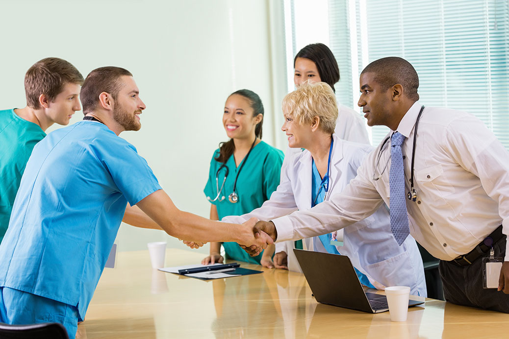 Hospital staff interviewing potential employees in board room